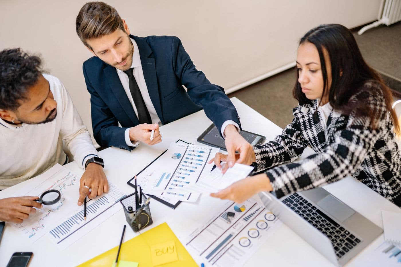 A team working around a table. The human layer behind an AI-native acquisition machine.